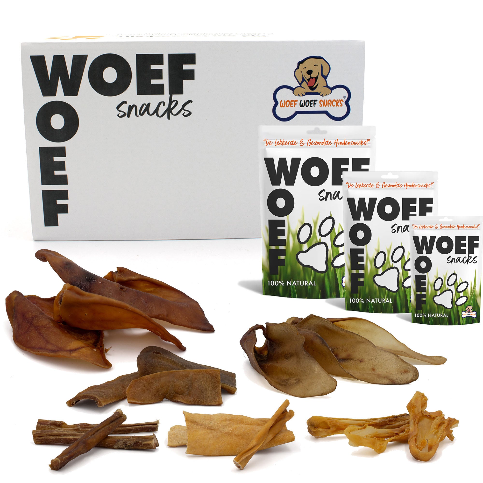 Kauwsnackbox voor honden die van kauwen houden en dat goed kunnen. De snackbox bevat zes soorten snacks. In de foto zie je een snackbox en zakken in verschillende formaten. Ook liggen er wat hondensnacks bij.